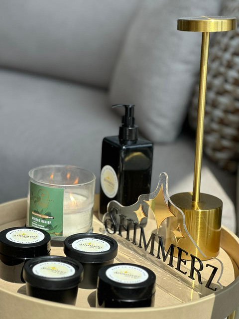 Shimmerz tray with a stress-relief candle and product jars