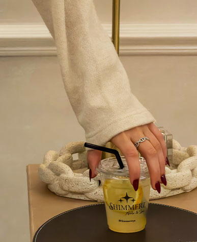 Freshly manicured hand with a Shimmerz branded drink
