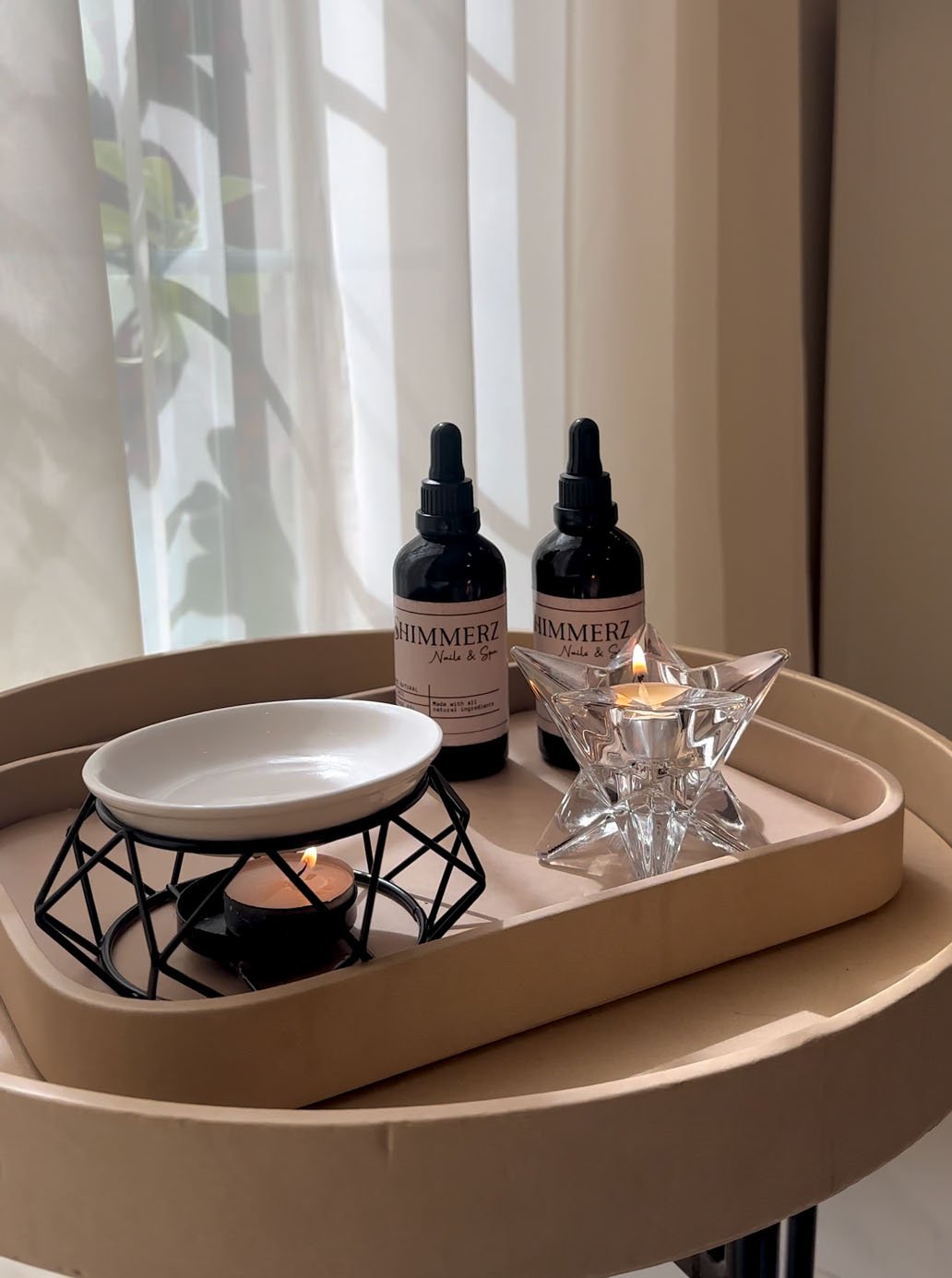 Shimmerz styling tray with oils and a lit candle