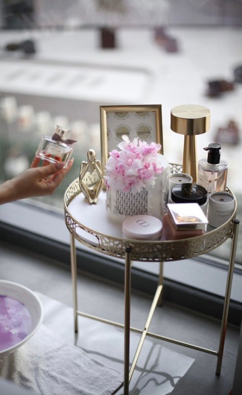Vanity table styled with fragrance and skincare products