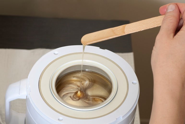 Warm wax being prepared for a waxing treatment